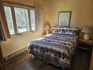 A bedroom with a bed, a window, a nightstand, a lamp, and a framed picture on the wall. - 2BR/2B Condo with Hot Tub/Pool access. 4.5 Miles to Jackson Hole Mountain Resort (Wilson)