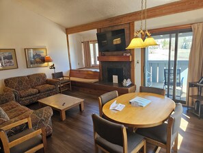 A living room with a sofa, chairs, a coffee table, a fireplace, and a dining table. - 2BR/2B Condo with Hot Tub/Pool access. 4.5 Miles to Jackson Hole Mountain Resort (Wilson)