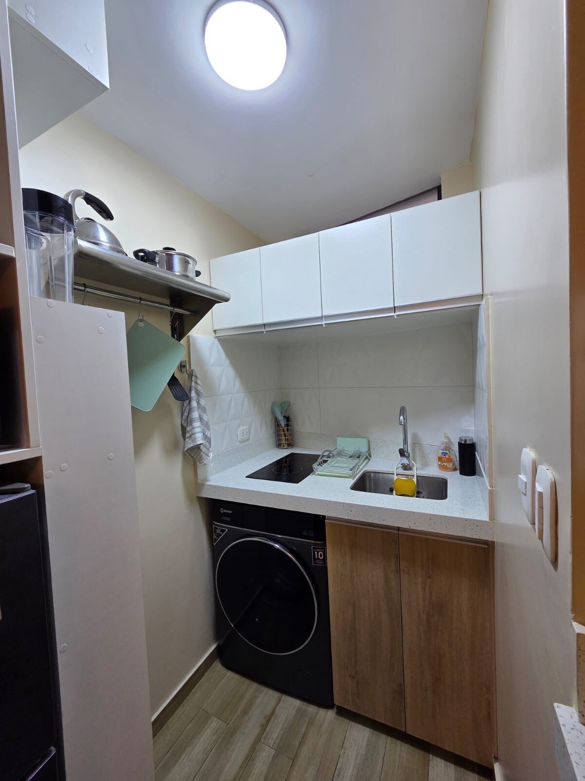 A compact kitchen with a dishwasher, a sink, and a stove.