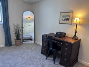 A room with a desk, chair, lamp, and a mirror reflecting a bed and a window. - New listing! Hot tub; game room; renovated 2026 (McGaheysville)
