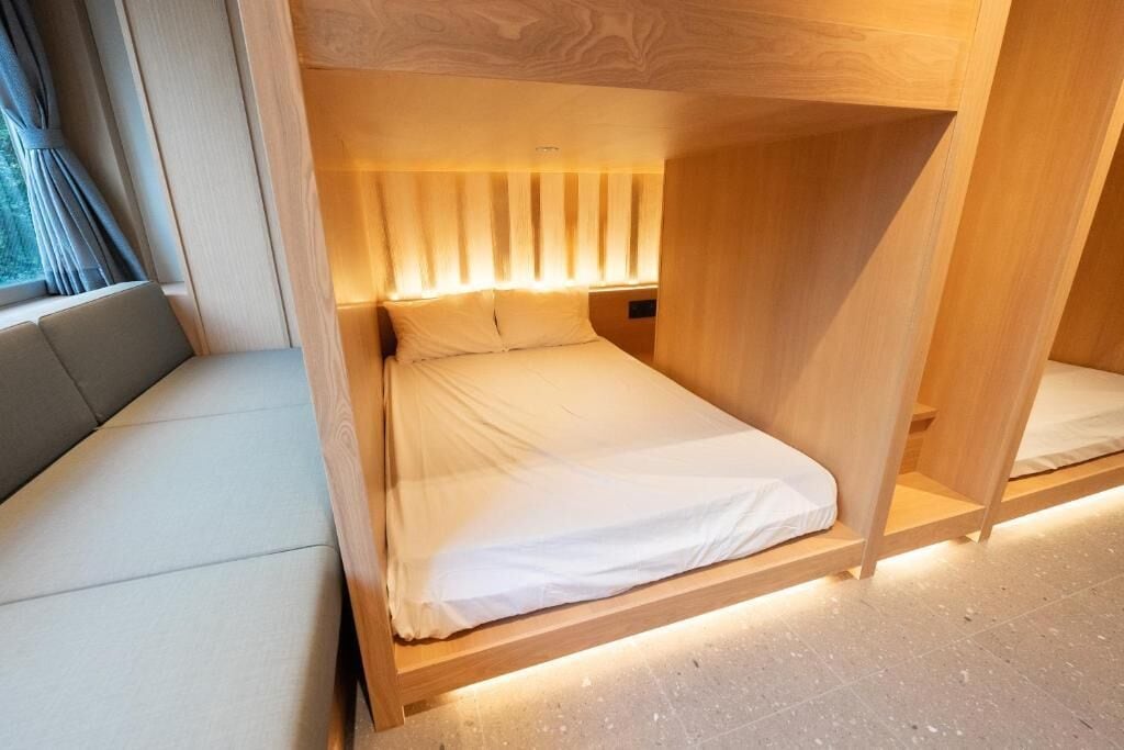A single bed with a wooden frame and a headboard with vertical slats.