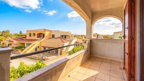 A balcony with a view of neighboring buildings and a clear sky. - Budoni Beach Homes, Budoni, Italy (Budoni)