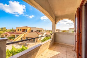 A balcony with a view of neighboring buildings and a clear sky. - Budoni Beach Homes, Budoni, Italy (Budoni)