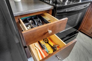A kitchen drawer with utensils and cookware. - Spacious Main-Floor Bungalow | Sleeps 6 | Near South Common & Southgate Mall (Edmonton)