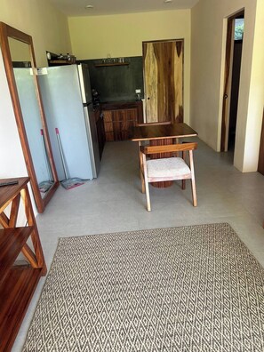 A spacious living area with a dining table and a patterned rug. - ModernBlair Vacation Rentals (Tulum)