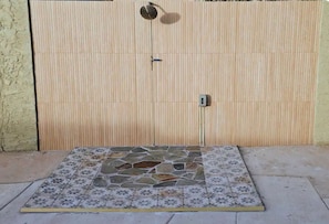 A tiled patio area with a wooden fence in the background. - Resort-Style Private suite #2 Near PHX with Pool/Gym (Phoenix)