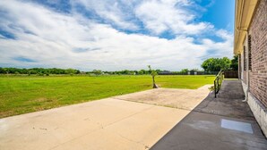 A paved walkway leading to a building with a brick exterior. - Family Country Home | Gaming, Workspace, Yard (Terrell)
