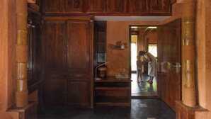 A wooden hallway with a staircase leading to a room. - Sukumara Homestay Unique Eco Luxury Mud and Bamboo Beachfront Villa (Thrissur)
