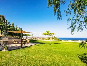 A patio with outdoor furniture and a barbecue area. - Leyland by Interhome (Faliraki)