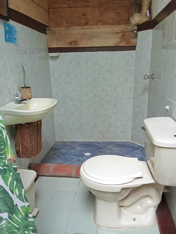 A small bathroom with a sink, toilet, and shower area. - Room Mirador, Casa Del Pueblo (Jardín)