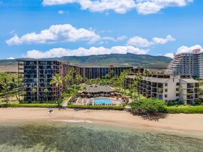 A resort with multiple buildings, a swimming pool, and a beach. - Large 1BR condo, partial ocean view, pool, beach access - Kaanapali Shores 414 (Lahaina)