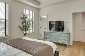 A bedroom with a bed, dresser, and a television. - Pool Access! Centrally Located ATL Escape w/ Deck (Atlanta)