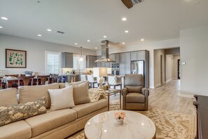 A modern living room with a sofa, armchair, and coffee table.
