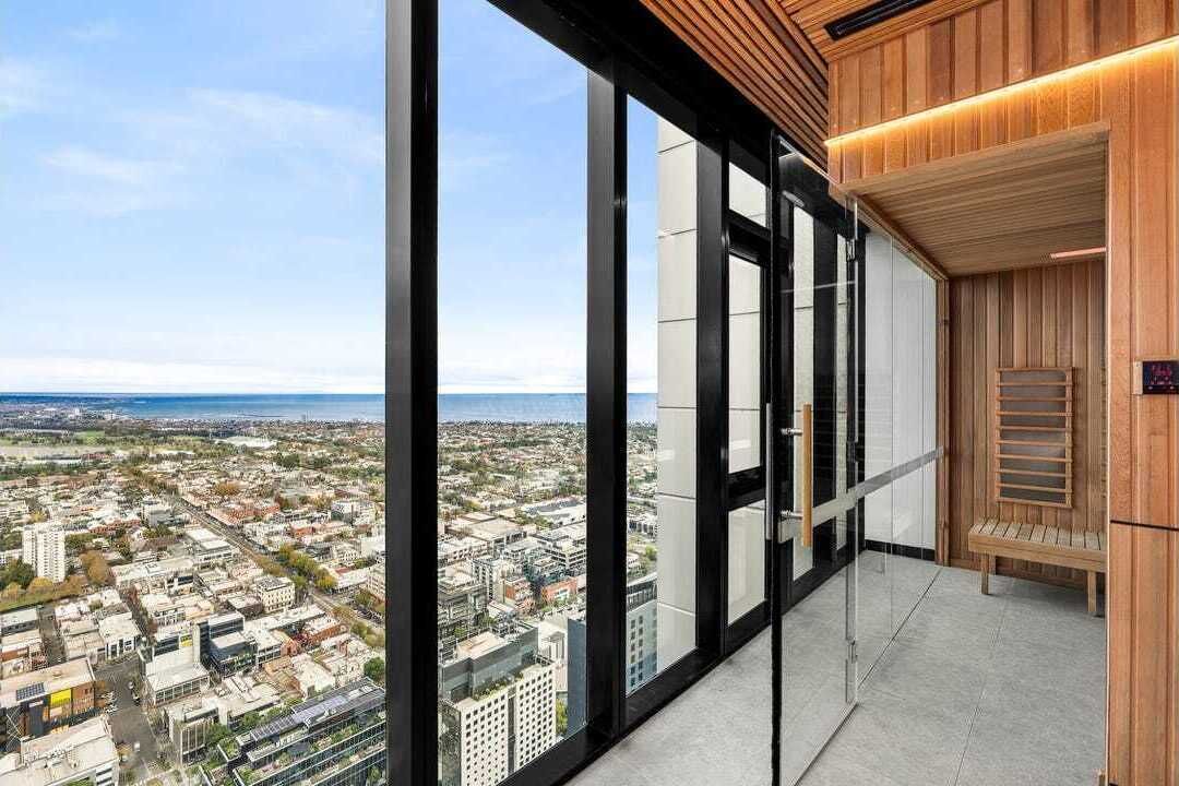 A high-rise building with large windows offering a city view.