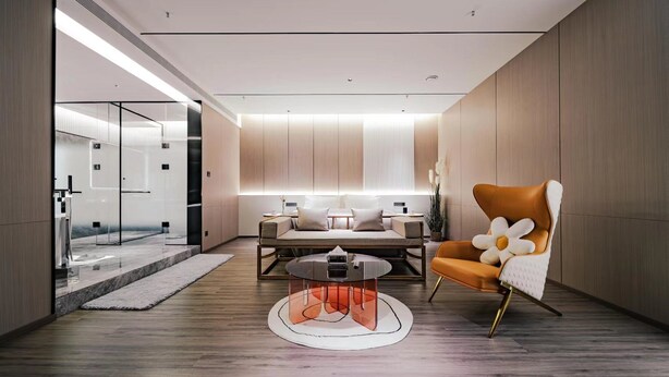Un intérieur moderne comprenant un coin salon, une table basse et un fauteuil original en forme de fleur.