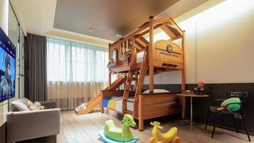 A children's play area with a bunk bed, a slide, and a small table with a toy figure.