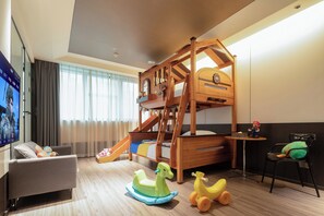 A children's play area with a bunk bed, a slide, and a small table with a toy figure. - Xian Jing - Scenery Hotel (Xi'an)
