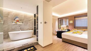 A hotel room with a bathtub, a bed, a desk, and a window with curtains.