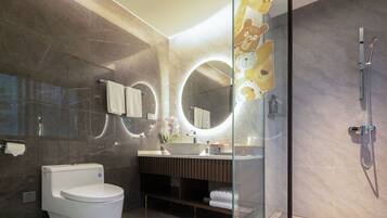 A modern bathroom with a toilet, sink, and shower.