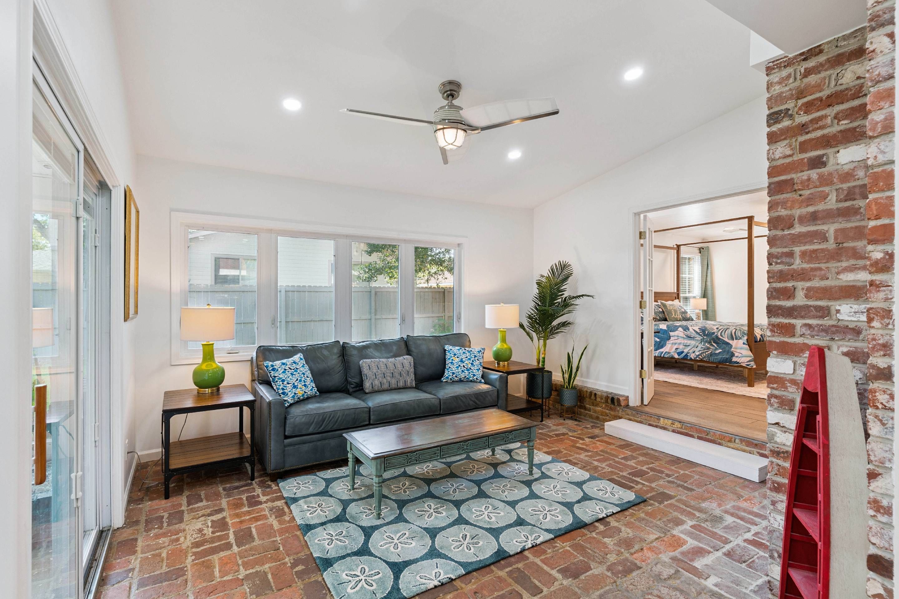 A living room with a sofa, coffee table, and a patterned rug.