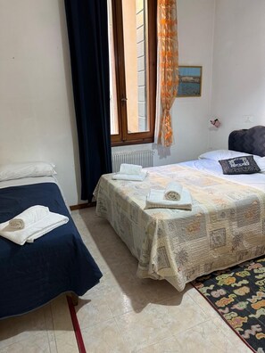 A room with two beds, a window with curtains, a radiator, and a small picture on the wall. - ALLOGGI ALLA SCALA (Venice)