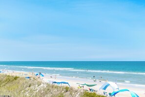 A beach with clear skies, a sandy shore, and people enjoying the water. - Dunebeg - 3BR Oceanfront Townhome; Great Views! (North Topsail Beach)