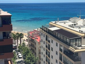 A high-rise building with multiple balconies overlooking a beach and the sea. - Sea View Retreat - Beachfront Two-Bedroom Penthouse (Calpe)