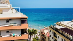 A coastal building with balconies overlooking a beach and the sea. - Sea View Retreat - Beachfront Two-Bedroom Penthouse (Calpe)