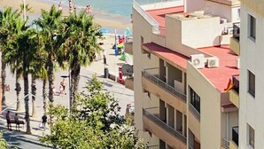 A coastal view with a beach, ocean, and buildings in the foreground. - Sea View Retreat - Beachfront Two-Bedroom Penthouse (Calpe)