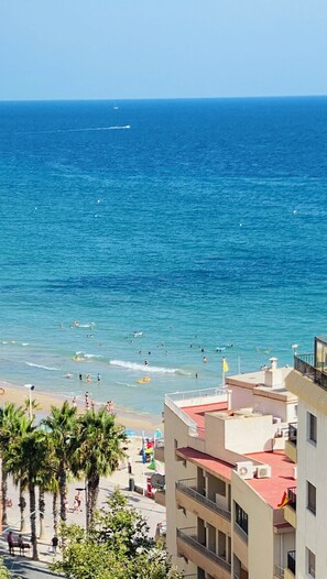 A coastal view with a beach, ocean, and buildings in the foreground. - Sea View Retreat - Beachfront Two-Bedroom Penthouse (Calpe)