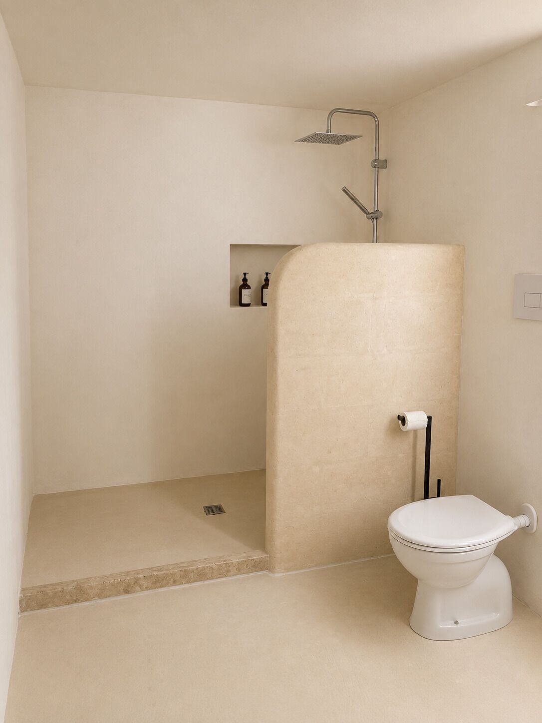 A bathroom with a shower, toilet, and a shelf with toiletries.