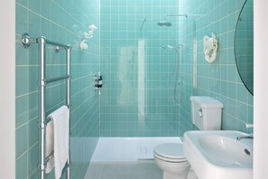 A bathroom with a bathtub, toilet, and sink.