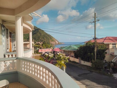 Hillside home with stunning sea views next to Roseau
