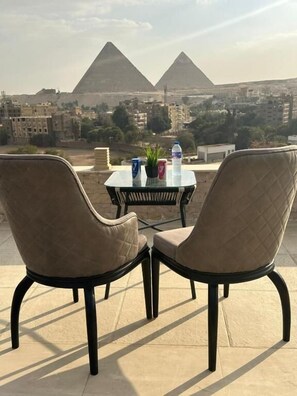 Quadruple Room, City View | Outdoor dining - city plaza pyramid view (giza)