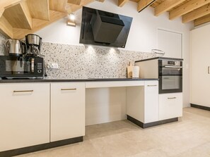 A modern kitchen with a microwave, coffee maker, and oven. - Renovated cottage in serene countryside (Saint-Père-en-Retz)