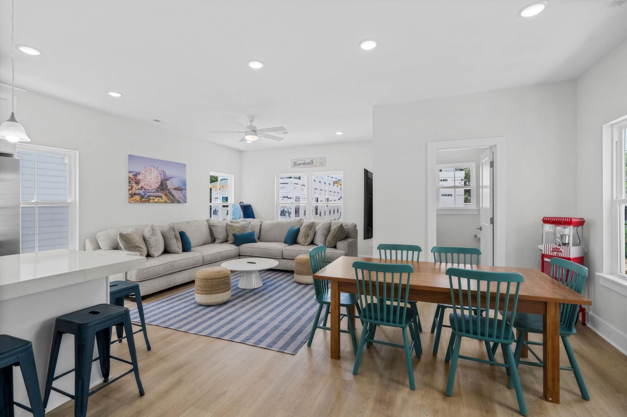 A modern kitchen with a white countertop, a built-in oven, and a ceiling fan.