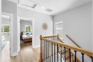 A modern interior with a staircase, a bedroom with a view, and a balcony. - Swell House 2.5 Blocks to Ocean Pet Friendly (Myrtle Beach)