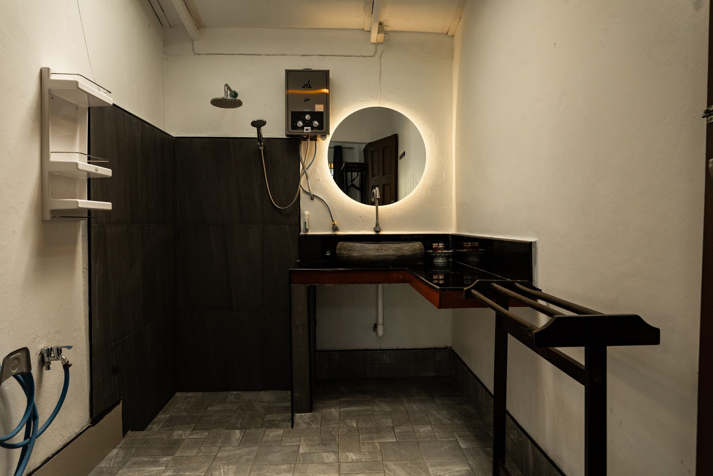 A bathroom with a shower, a sink, and a mirror.