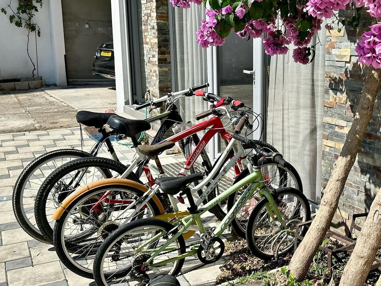 A bicycle rack with multiple bicycles parked.