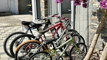 A bicycle rack with multiple bicycles parked.