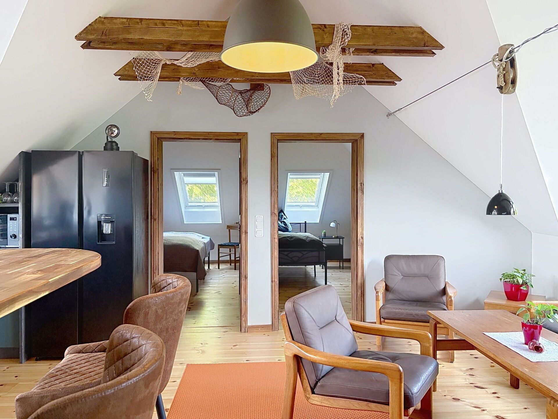 Ein modernes Loft mit Küche, Essbereich und zwei Schlafzimmern mit Dachfenstern.
