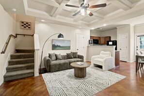 A spacious living area with a staircase, a sofa, a coffee table, and a ceiling fan. - 16801-SD2 • Spacious Family Townhome•3BR• Backyard• Fast Wi-Fi (Selma)