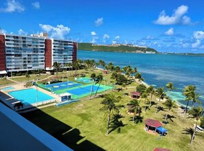 A hotel with multiple floors, a pool area, and a view of the ocean. - Waterfront Condo, Private Marina Island,
Fajardo (Fajardo)