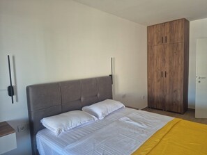 Une chambre à coucher avec un lit, une armoire et une table de chevet.