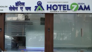 A hotel sign with the name 'HOTEL 7 AM' and a logo. - 7AM By Glitz Hotels (Mumbai)