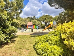 A playground with slides and climbing structures surrounded by greenery. - Studio with a terrace and parking in La Rochelle (La Rochelle)