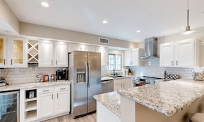 A modern kitchen with white cabinetry, stainless steel appliances, and granite countertops. - NEW Desert Gem | Spacious 2BR Tucson Getaway (Tucson)