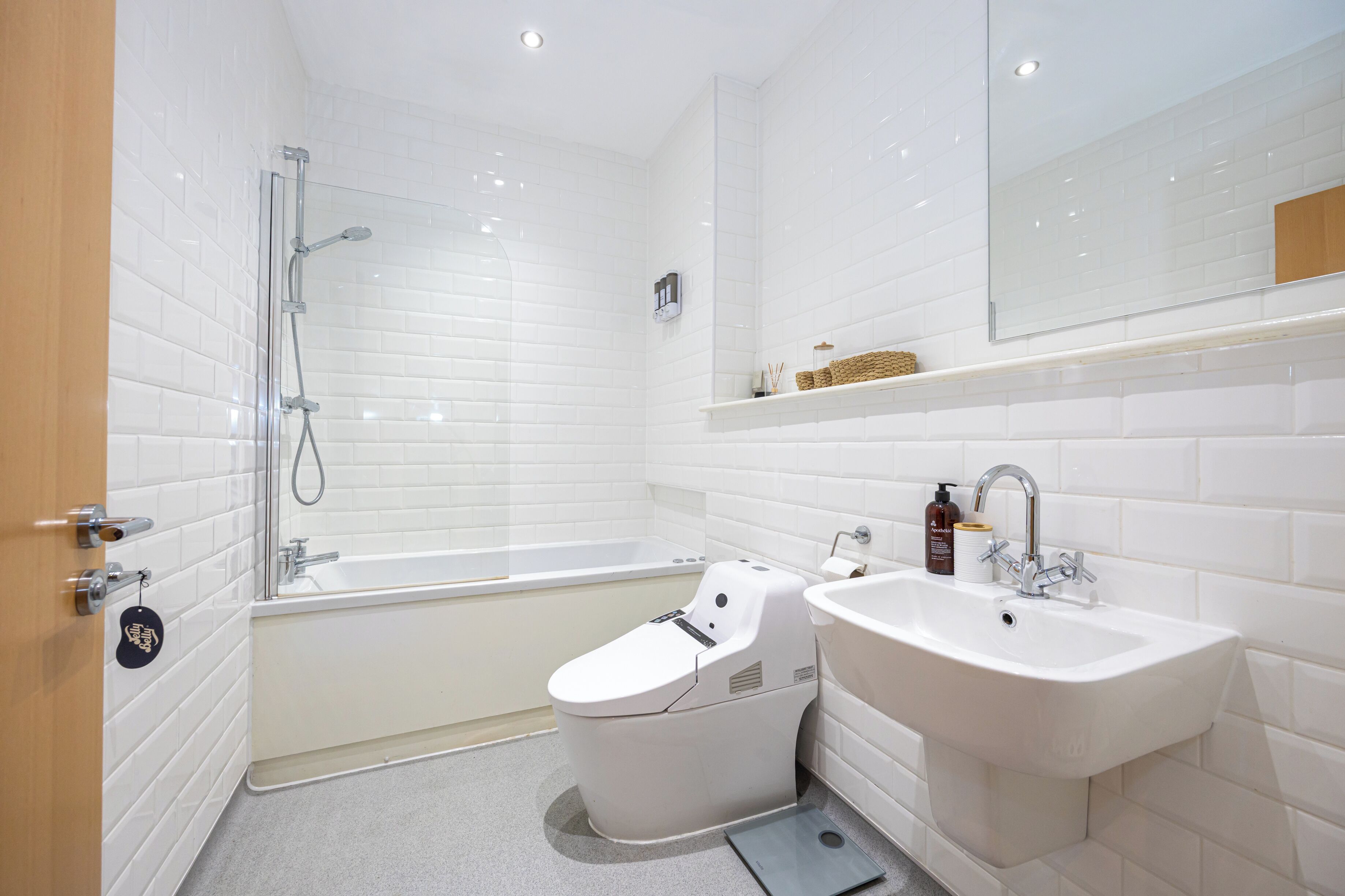 A modern bathroom with a bathtub, a toilet, and a sink.