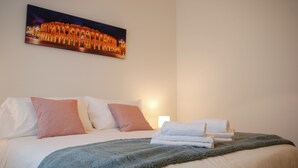 A hotel room with a neatly made bed, a blanket, and a pillow. - Double Space Apartment - Milan - 6 guests · Airport · Train · Garage (Milano)
