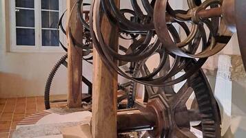 A mechanical device with large wheels and a central shaft, possibly a historical exhibit or installation.